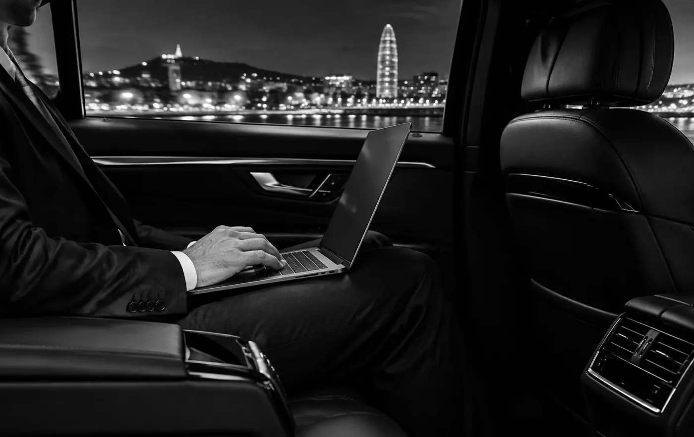Executive working on a laptop in the rear seat